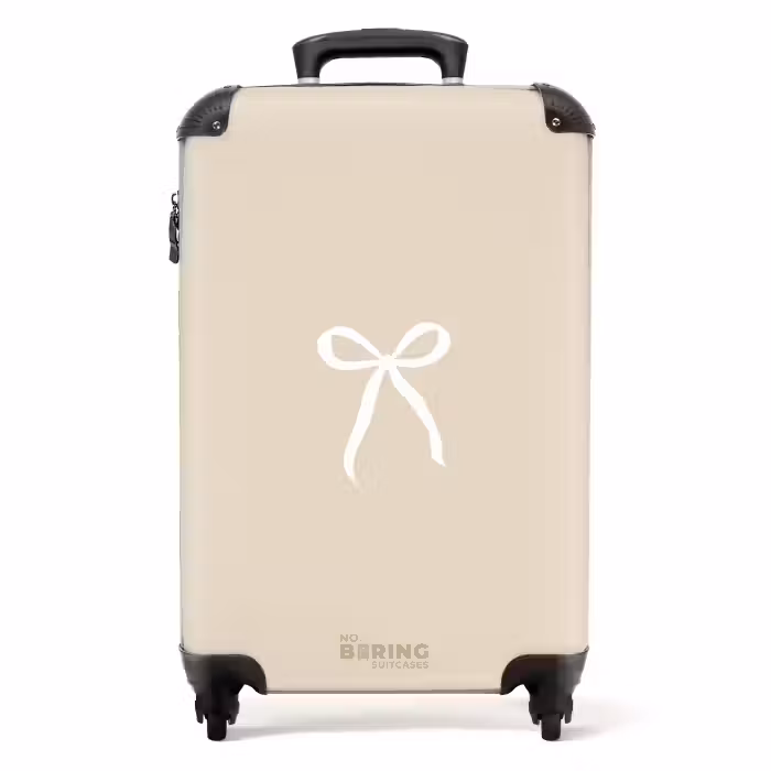 Suitcase - White bow on beige background